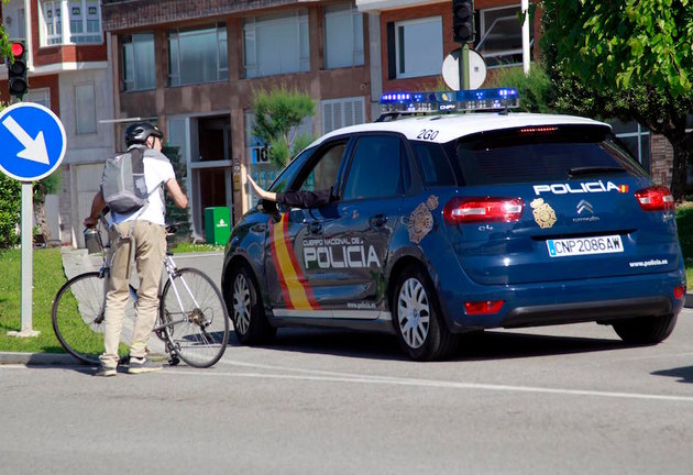 Una patrulla de la Policía Nacional da indicaciones a un ciudadano que sostiene su bicicleta en el segundo día desde que comenzó la &#39;fase 0&#39; de la &#34;desescalada&#34;. / J. RAMÓN