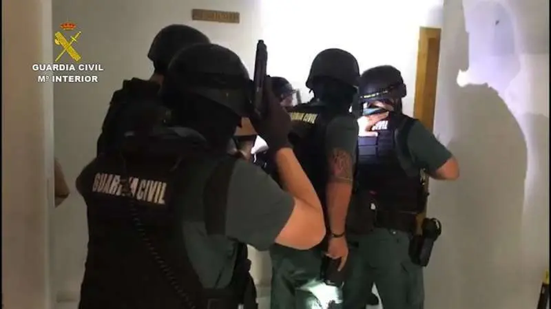 Un grupo de agentes se dispone a entrar en la casa de uno de los detenidos.