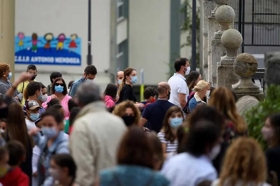 Padres y alumnos a la entrada del Colegio Cumbres, este lunes en Santander. Los alumnos de Infantil y Primaria vuelven a las aulas de Cantabria en un inicio de curso escolar marcado por el repunte de casos de coronavirus y las medidas sanitarias para minimizar los contagios en los centros educativos. EFE/Pedro Puente Hoyos