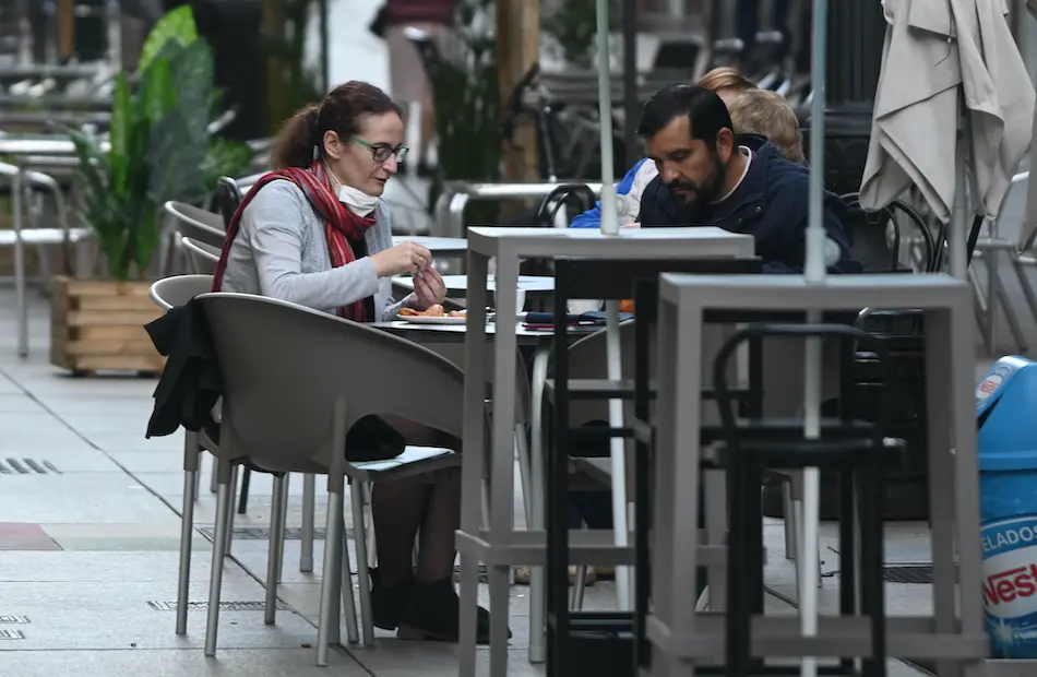 Dos personas desayunan en una cafeter&iacute;a del centro de Santander. / HARDY