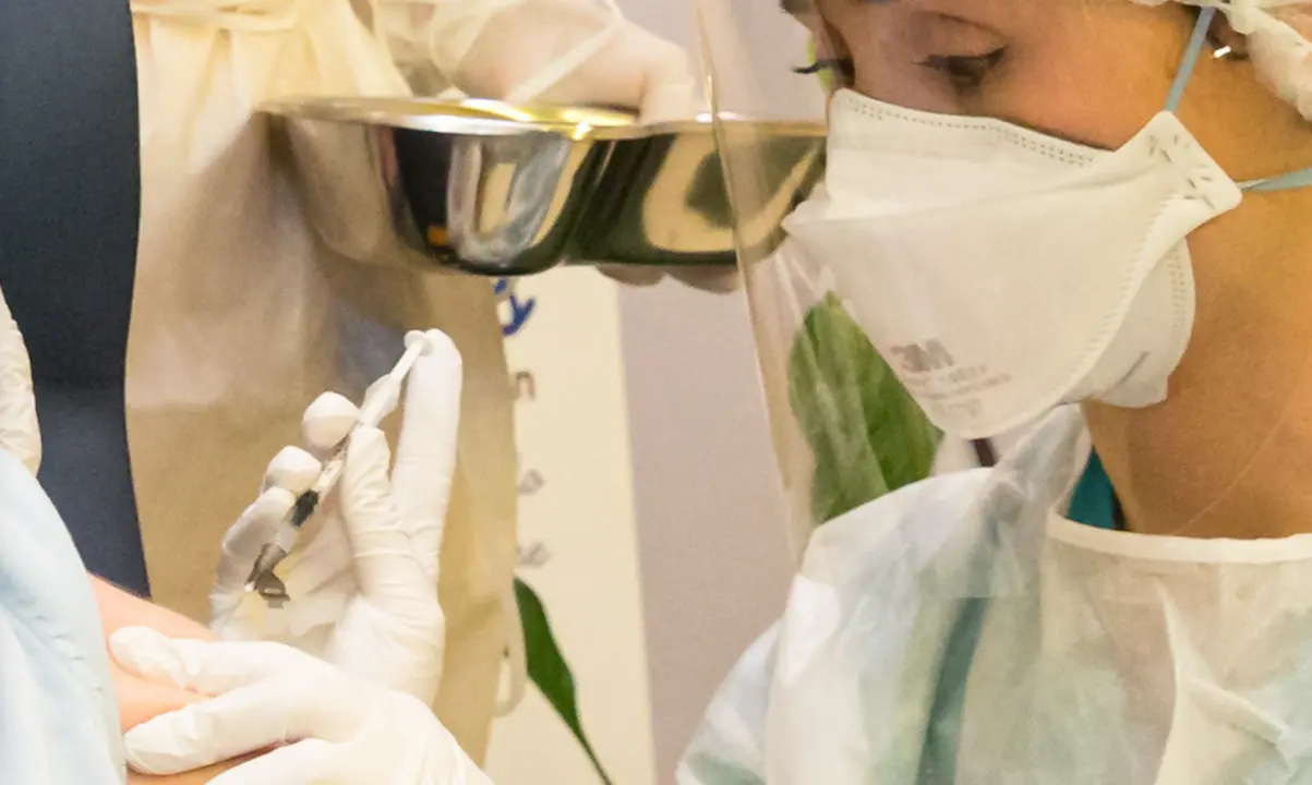 Una sanitaria del SCS administra una dosis a una paciente c&aacute;ntabra en el CAD de Cueto. / ALERTA
