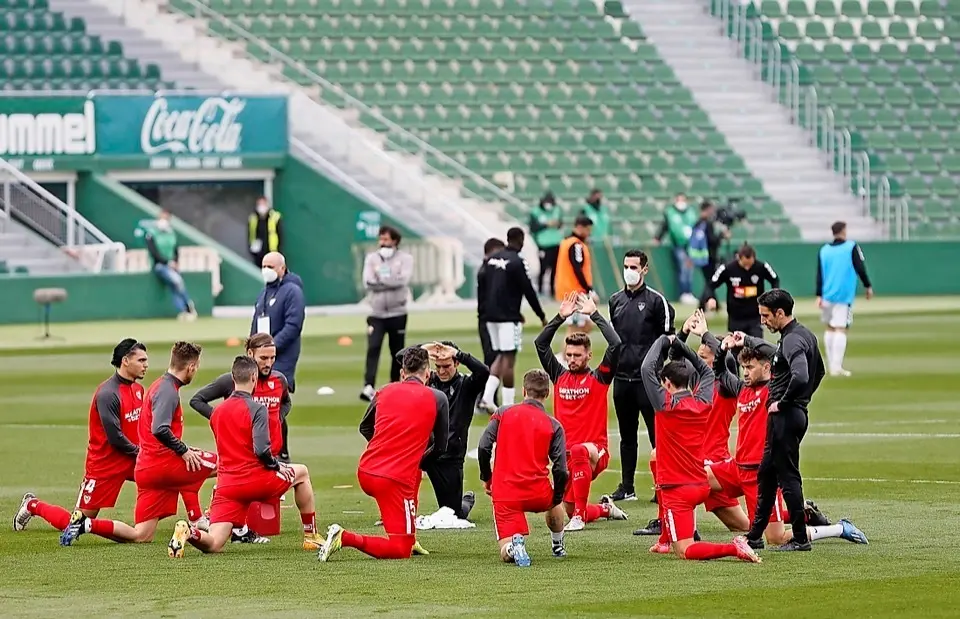 ELCHE (ALICANTE), 06/03/2021.- Los jugadores del Sevilla y el Elche (al fondo) durante el calentamiento previo al partido de la vig&eacute;simo sexta jornada de Liga que disputan hoy en el estadio Mart&iacute;nez Valero de Elche. EFE / Manuel Lorenzo