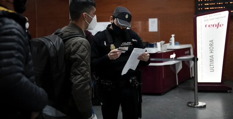 Un agente de Polic&iacute;a Nacional pide documentaci&oacute;n a un pasajero en la estaci&oacute;n de Atocha, en Madrid (Espa&ntilde;a), a 18 de marzo de 2021. / &Oacute;scar Ca&ntilde;as / Europa Press
