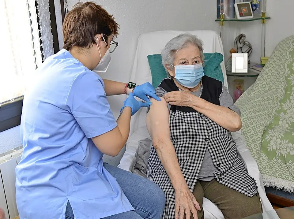 Un enfermera mide las constantes a una se&ntilde;ora en su domicilio tras ser vacunada. / efe