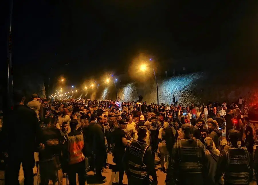 J&oacute;venes marroqu&iacute;es esperan el momento de cruzar la frontera, por tierra o agua, este lunes en la localidad de Castillejos. en Marruecos. La Delegaci&oacute;n del Gobierno en Ceuta ha informado esta noche que el n&uacute;mero de inmigrantes marroqu&iacute;es que ha conseguido entrar ilegalmente en la ciudad a lo largo de la jornada asciende ya a 5.000 personas . EFE/Mohamed Siali
