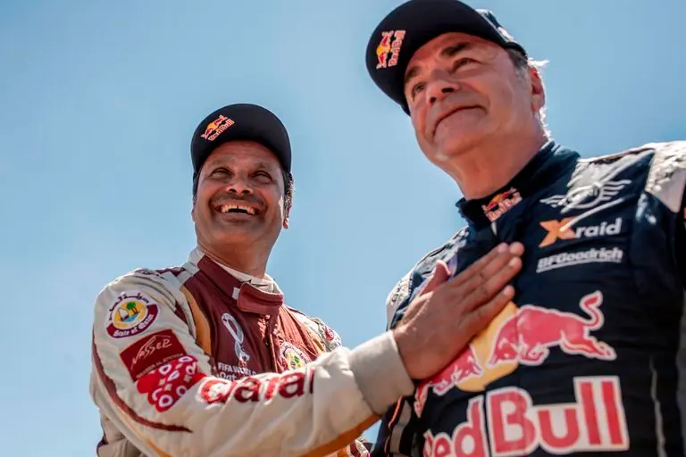 El piloto catar&iacute; Nasser Al-Attiyah, y el piloto Carlos Sainz (d), primer y segundo clasificado respectivamente, tras la cuarta etapa del Rally Andaluc&iacute;a 2021, prueba de preparaci&oacute;n para el Dakar 2022. EFE/ Brais Lorenzo