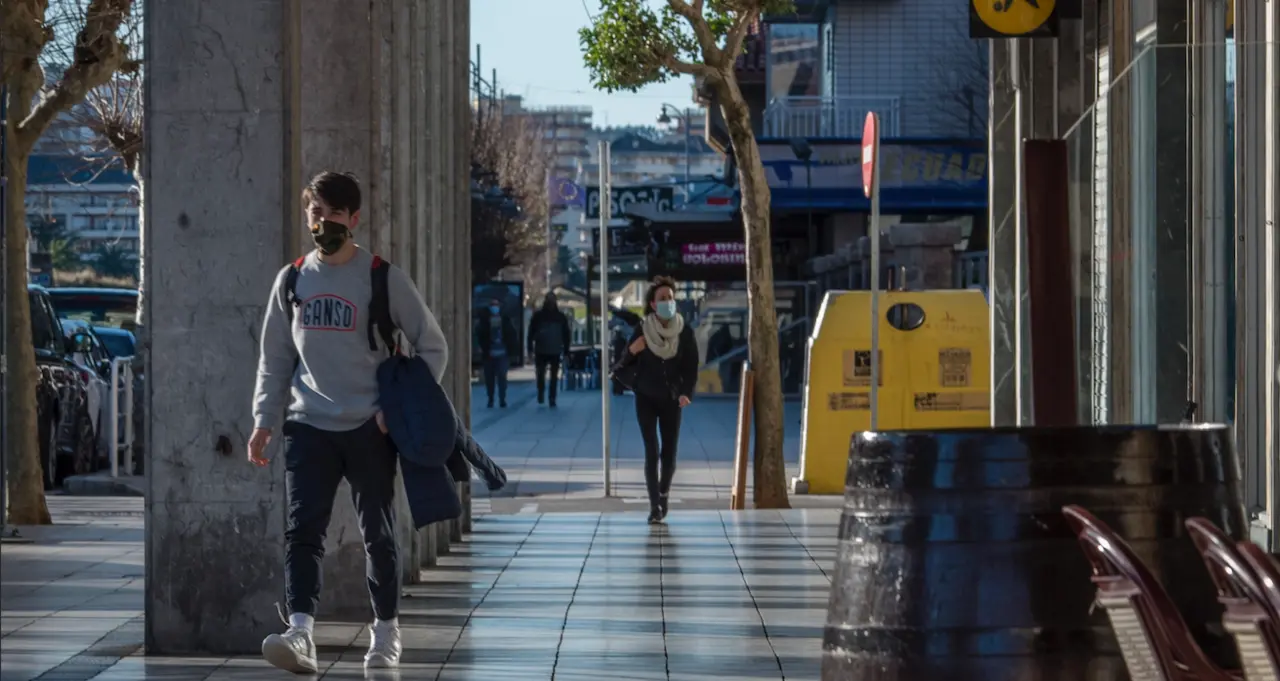 Varias personas con mascarilla por la localidad de Laredo. / T. Reguera
