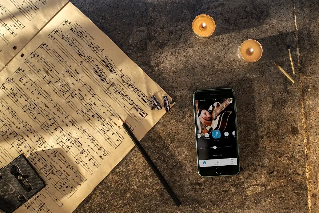 iPhone lying besides music program