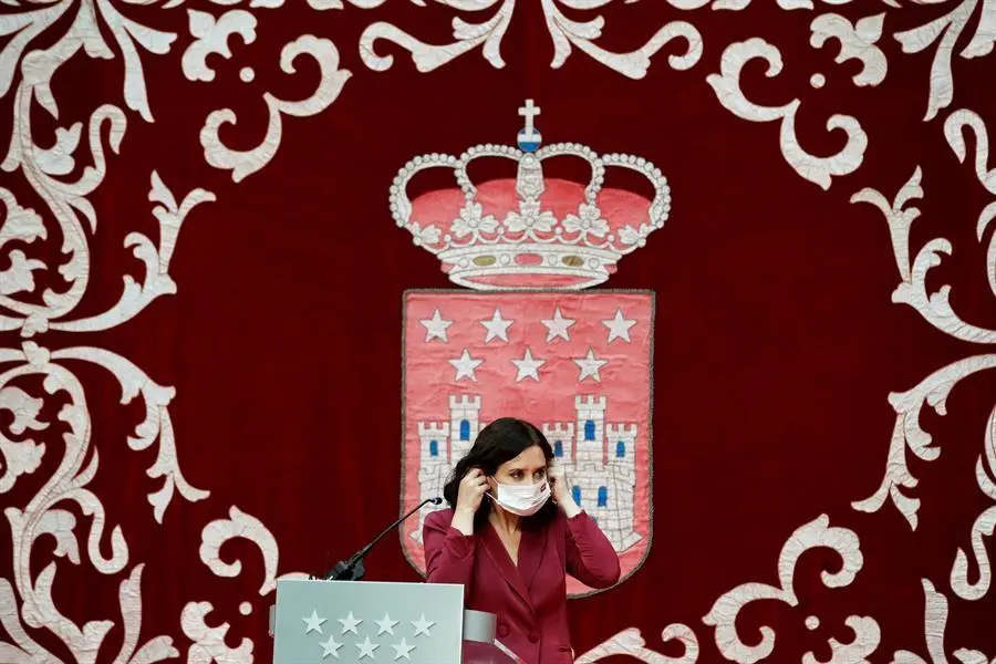La presidenta madrile&ntilde;a, Isabel D&iacute;az Ayuso, se coloca la mascarilla mientras preside la ceremonia de toma de posesi&oacute;n de los nuevos consejeros de la Comunidad de Madrid, este lunes, en la Real Casa de Correos. EFE/Juan Carlos Hidalgo