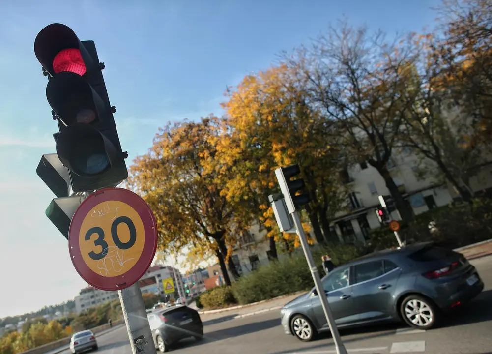 Archivo - Varios coches circulan al lado de una se&ntilde;al de tr&aacute;fico en una v&iacute;a de la capital el mismo d&iacute;a en que han aprobado la reducci&oacute;n de la velocidad hasta 20km/h en las ciudades y la p&eacute;rdida de seis puntos por usar el m&oacute;vil, en Madrid, (Espa&ntilde;a), a 10 d