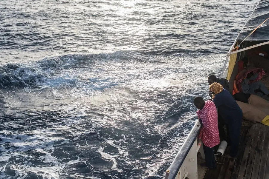 Archivo - Refugiados y migrantes miran por la borda en el Mediterr&aacute;neo desde la borda del Open Arms tras un rescate