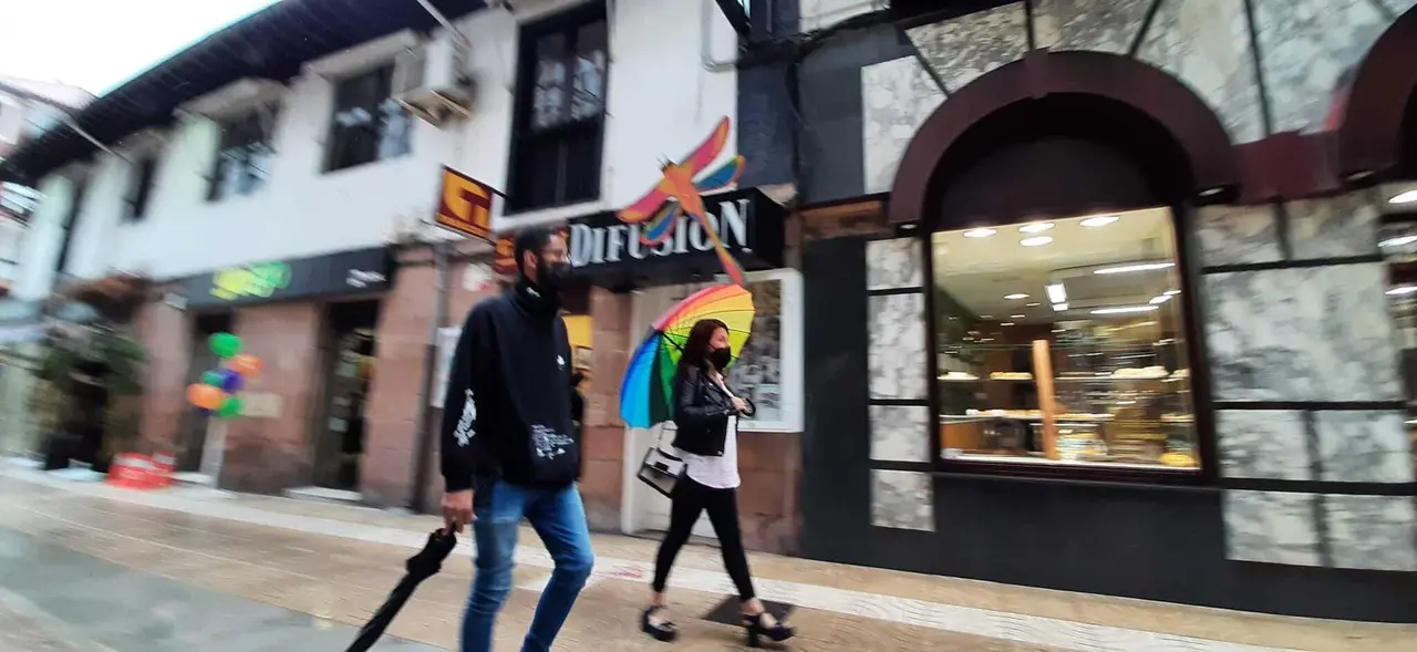 Dos personas caminan por la calle Consolaci&oacute;n de Torrelavega. / S. D&iacute;az