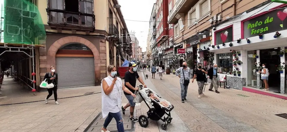 Varias personas transitan con mascarilla por la calle Escalante de Torrelavega. / S. D&iacute;az