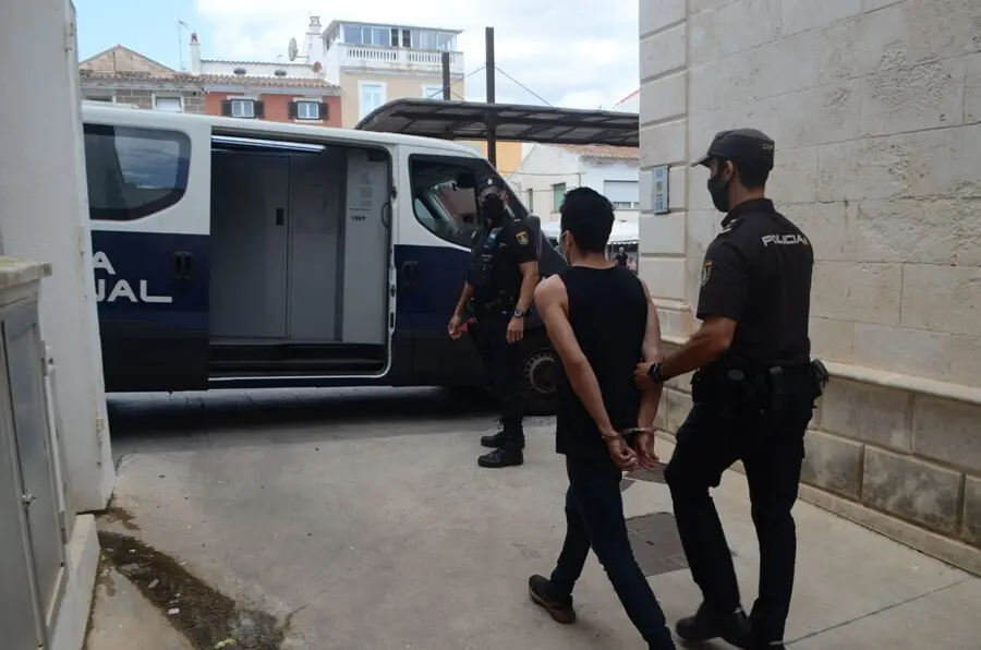 Agentes de la Polic&iacute;a Nacional, con uno de los detenidos.