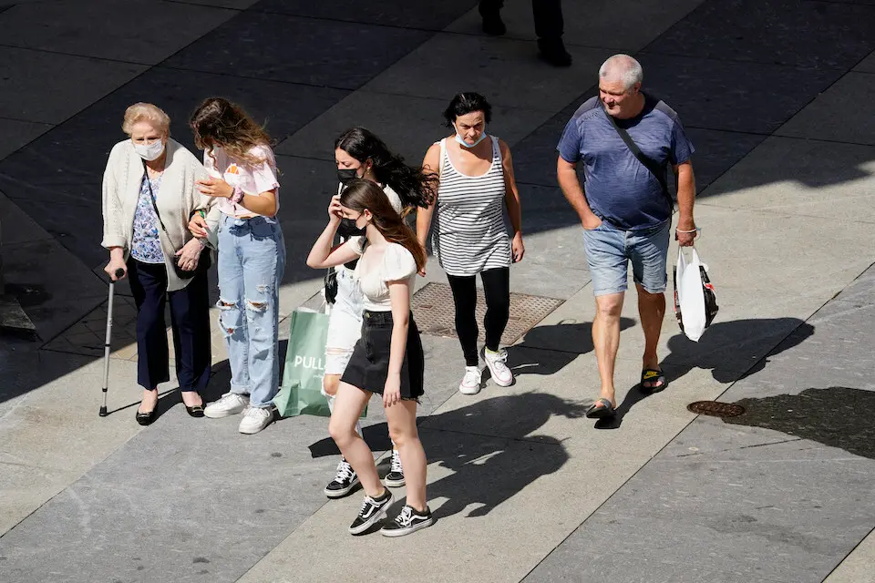 Varias personas transitan con mascarilla por el centro de Santander. / Hardy