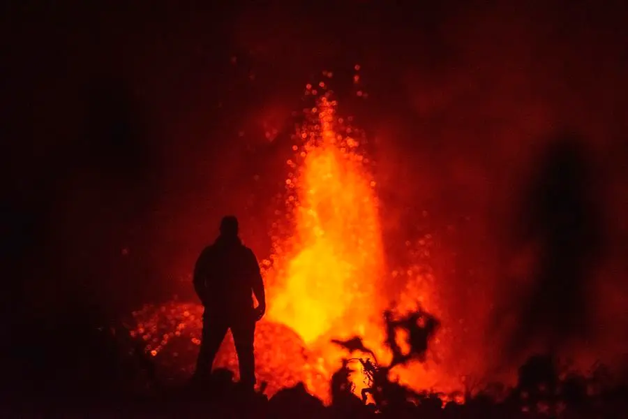 Imagen tomada en la madrugada de hoy, lunes 4 de octubre, en el municipio de El Paso del volc&aacute;n de La Palma, que est&aacute; a punto de completar su decimoquinto d&iacute;a de erupci&oacute;n, tras un derrumbe parcial en el cono principal al que han seguido emisiones m&aacute;s abundantes de lava. EFE/Carlos de Sa&aacute;