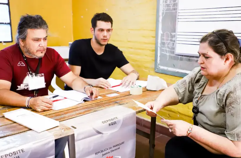Una mujer recibe una papeleta de votaci&oacute;n, hoy, en Asunci&oacute;n (Paraguay). EFE/Nathalia Aguilar