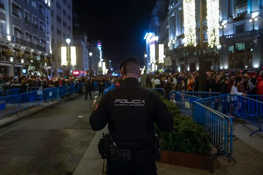 Un polic&iacute;a presta guardia en una calle que re&uacute;ne a decenas de ciudadanos. EFE / Daniel Gonz&aacute;lez