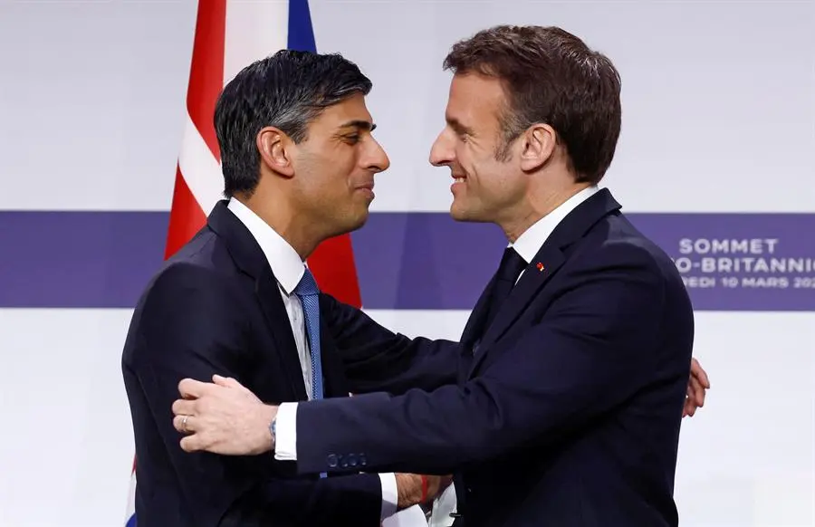 El presidente franc&eacute;s, Emmanuel Macron (d), y el primer ministro brit&aacute;nico, Rishi Sunak, se abrazan en una rueda de prensa conjunta este viernes en Par&iacute;s. / GONZALO FUENTES