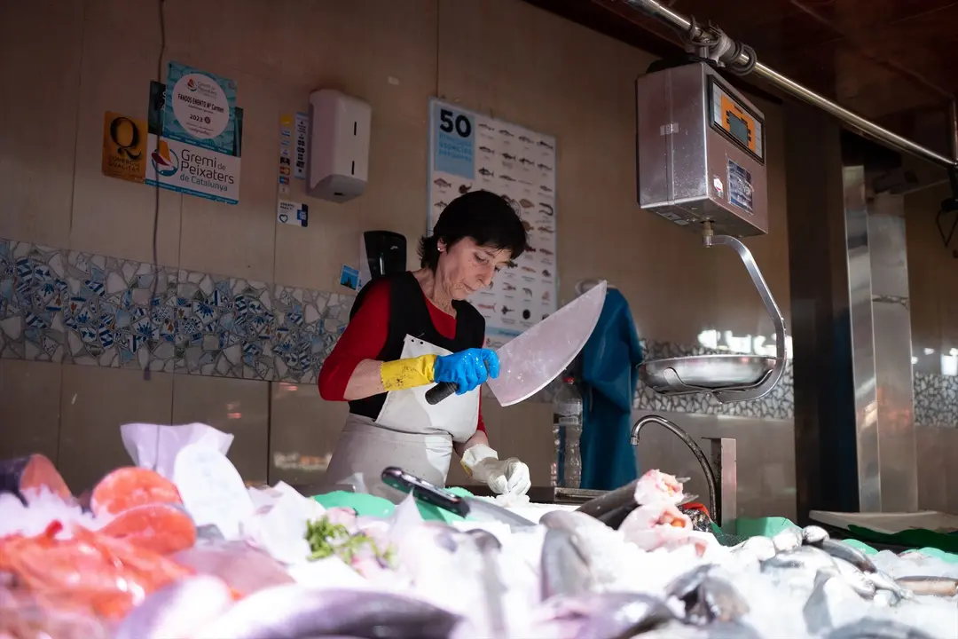 Una persona trabaja en un puesto en el mercado. David Zorrakino / Archivo