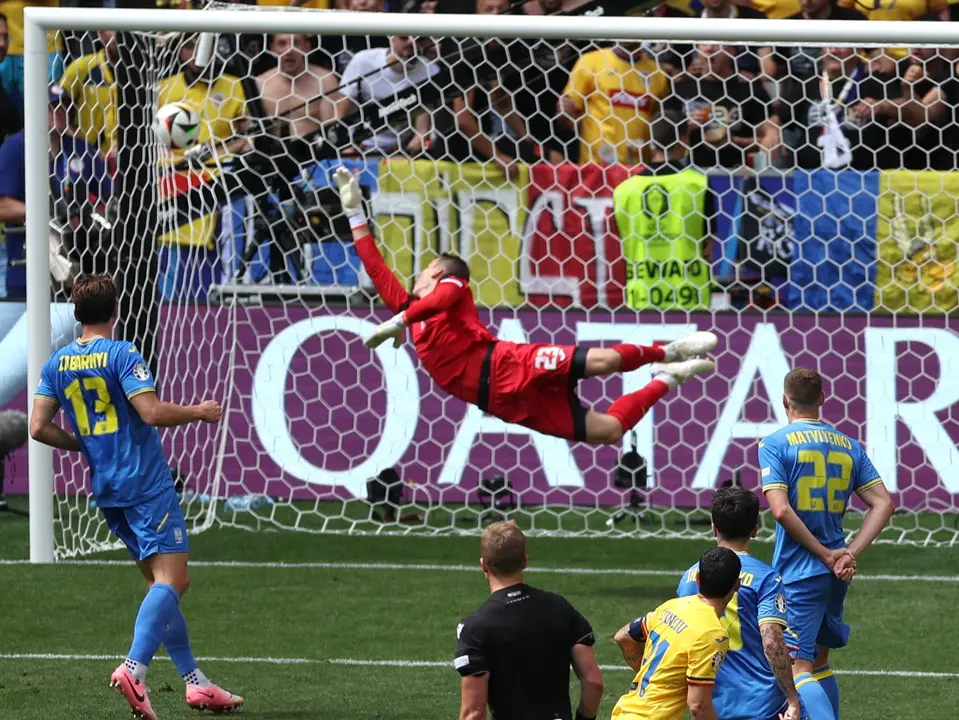 Lunin se estira para tratar de parar el gol de Ruman&iacute;a. / Red X EURO 2024