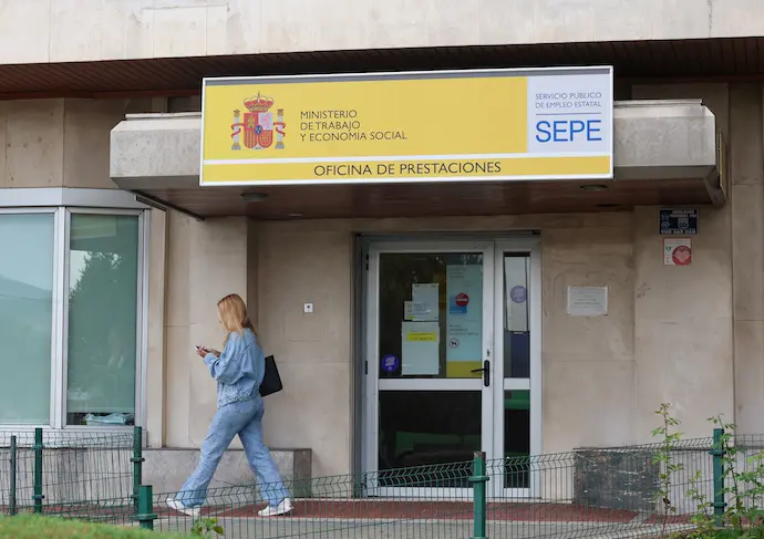 Una mujer al lado de una oficina del SEPE. / EP