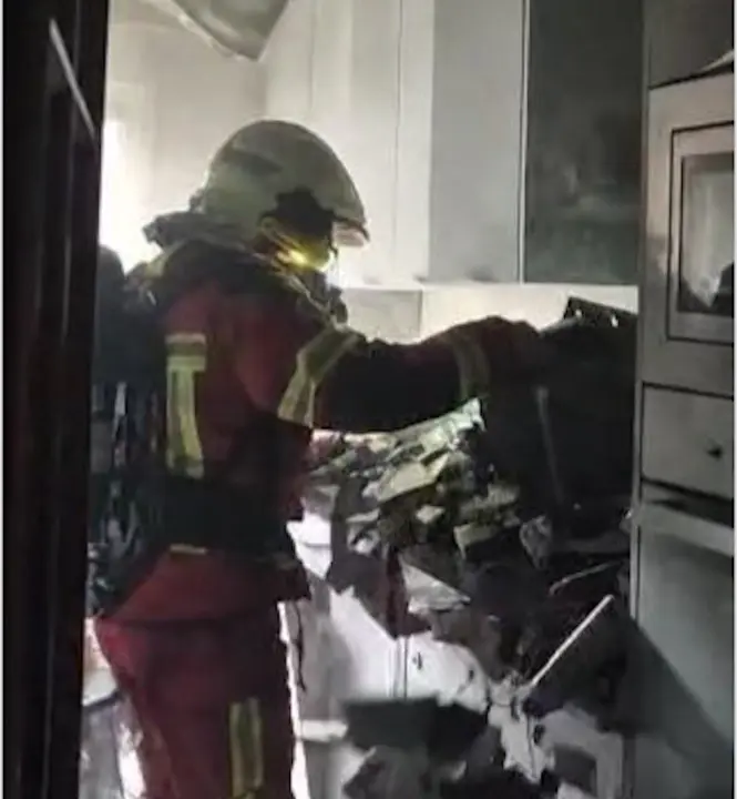 Uno de los bomberos en la casa incendiada. / 112
