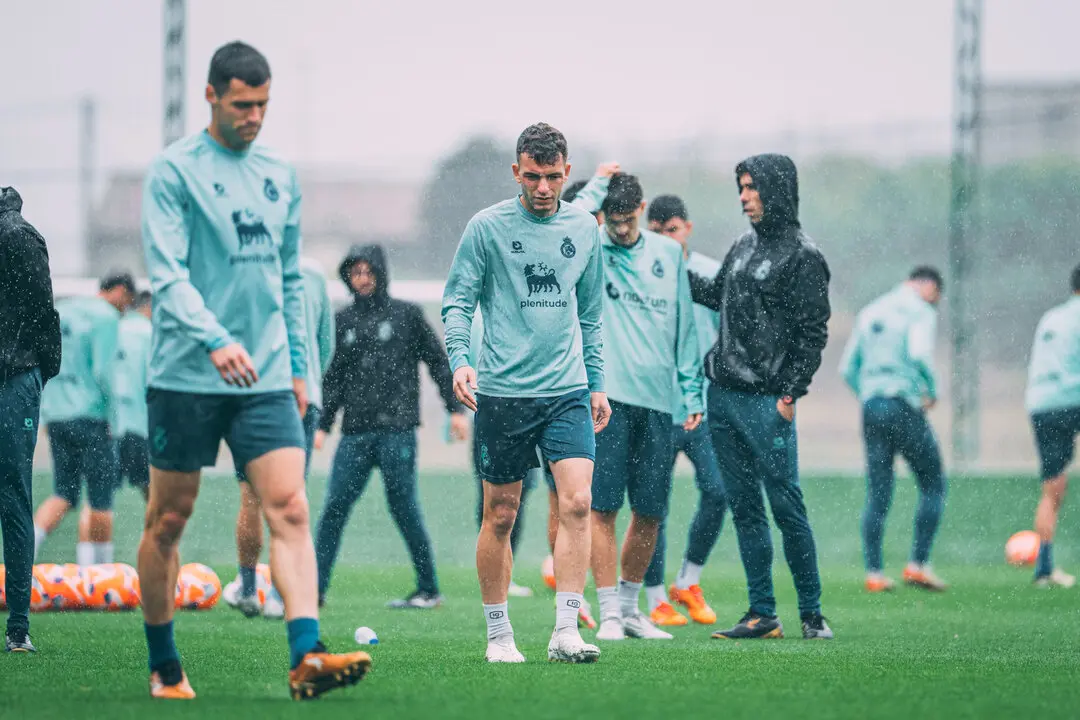 Los jugadores del Racing se ejercitan bajo la lluvia en La Albericia, concentrados en preparar la decisiva visita a Elda.