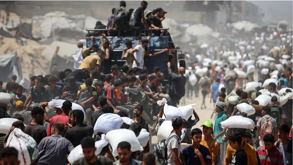 Habitantes de Gaza transportan alimentos lanzados desde el aire por Jordania y los Emiratos &Aacute;rabes Unidos el 27 de julio.
