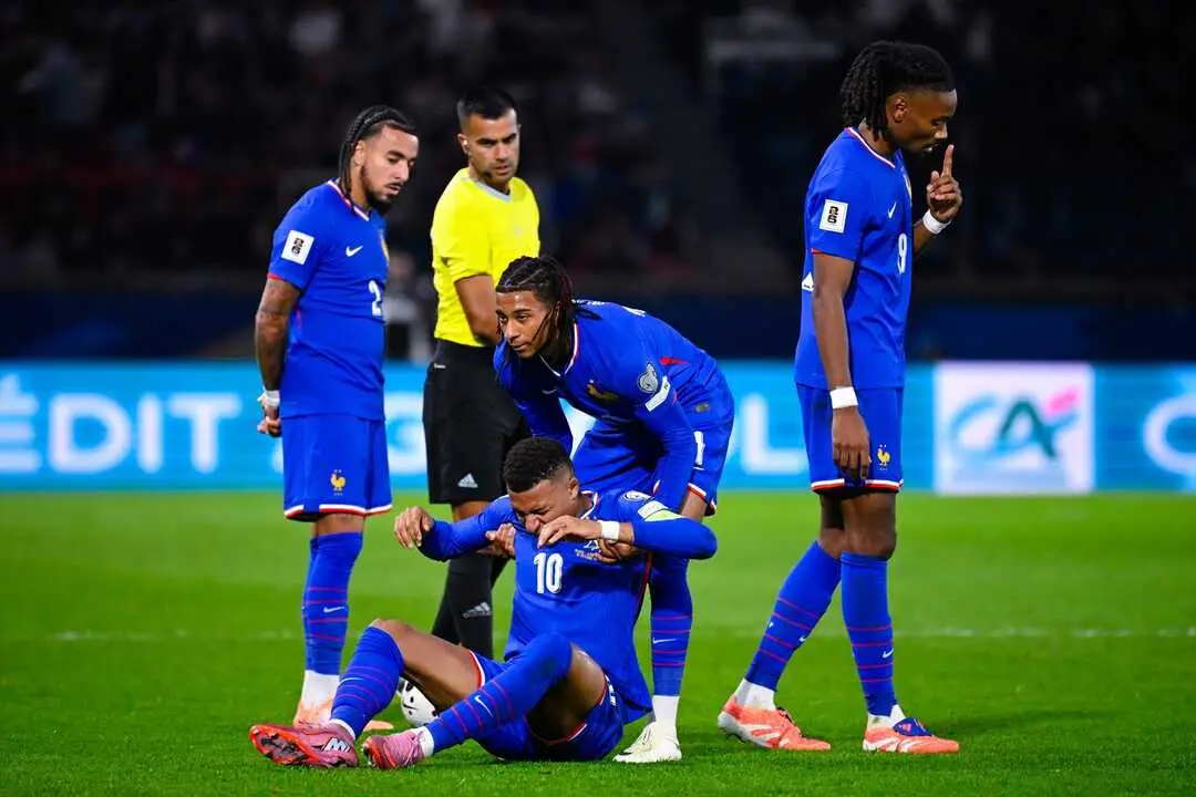 Mbapp&eacute;, ayudado por sus compa&ntilde;eros tras recibir un golpe. / EP