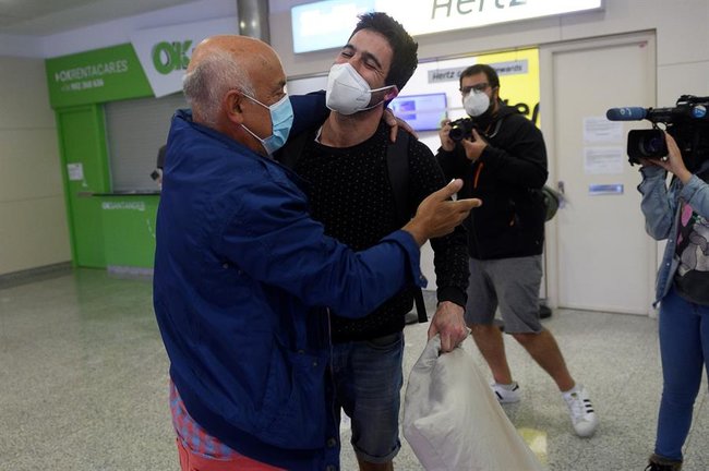 Un padre recibe a su hijo procedente de Viena este jueves en el aeropuerto Seve Ballesteros en Cantabria. FOTO/EFE/Pedro Puente Hoyos
