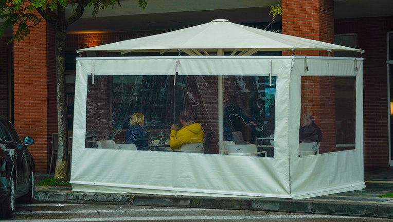 Varias personas bajo una carpa de una terraza en Santander. / Hardy