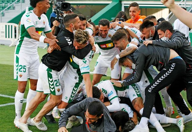 Los jugadores del Elche celebran la permanencia en Primera División tras el último partido de Liga ante el Athletic de Bilbao jugado hoy sábado en el estadio Martínez Valero. EFE/Manuel Lorenzo