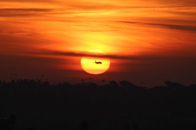 Un avión pasa por delante del sol. E.P.