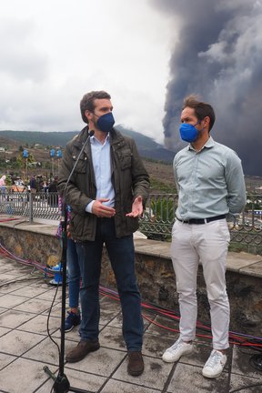 El presidente del Partido Popular, Pablo Casado (i), ofrece declaraciones de los medios en un mirador próximo al volcán