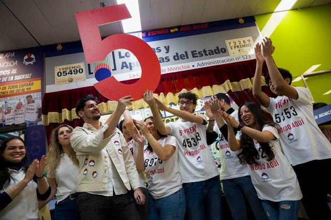 La administración 523, en Moncloa, Madrid, celebra tras haber vendido décimos del 92.023, agraciado con uno de los quintos premios, durante la celebración del sorteo extraordinario de Navidad de la Lotería Nacional, este viernes. EFE/Fernando Villar