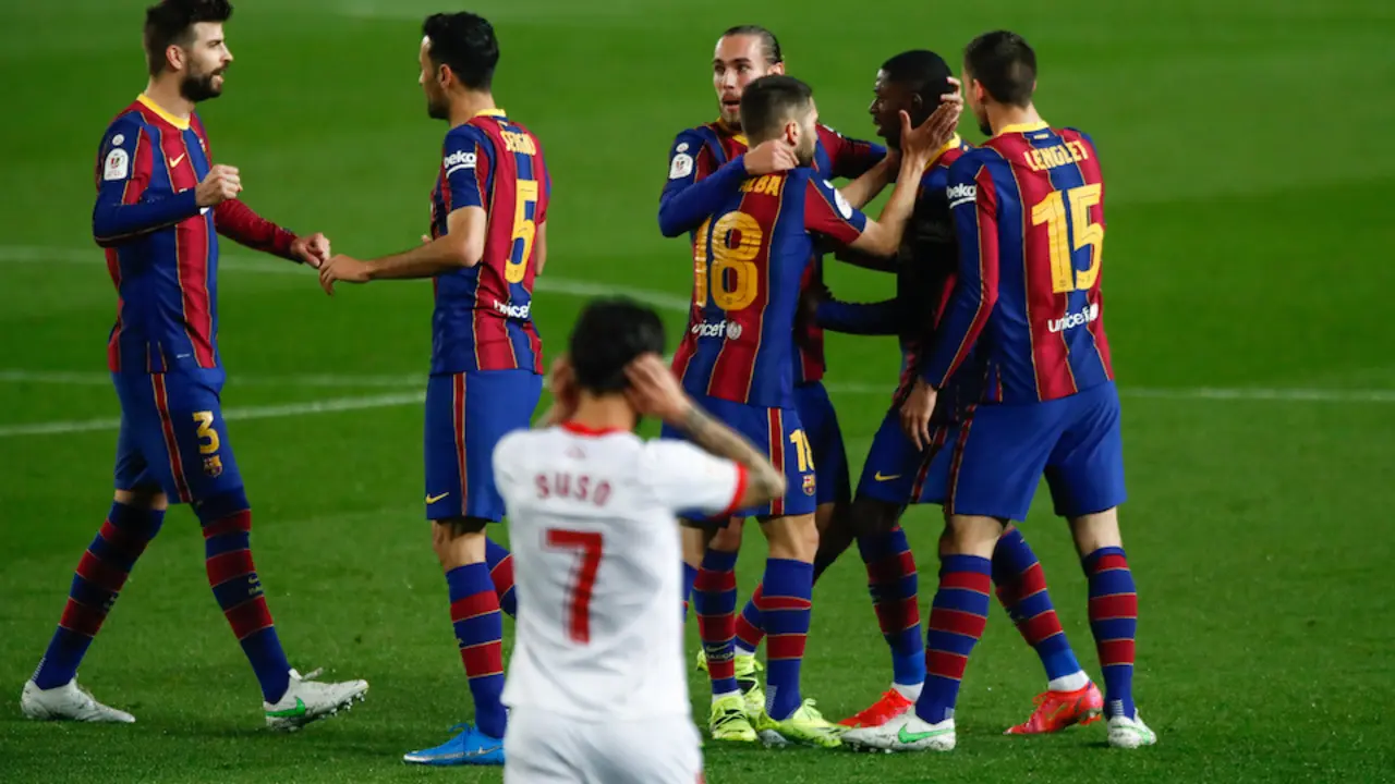Suso se lamenta mientras los jugadores del FC Barcelona festejan uno de los goles. / E. PRESS