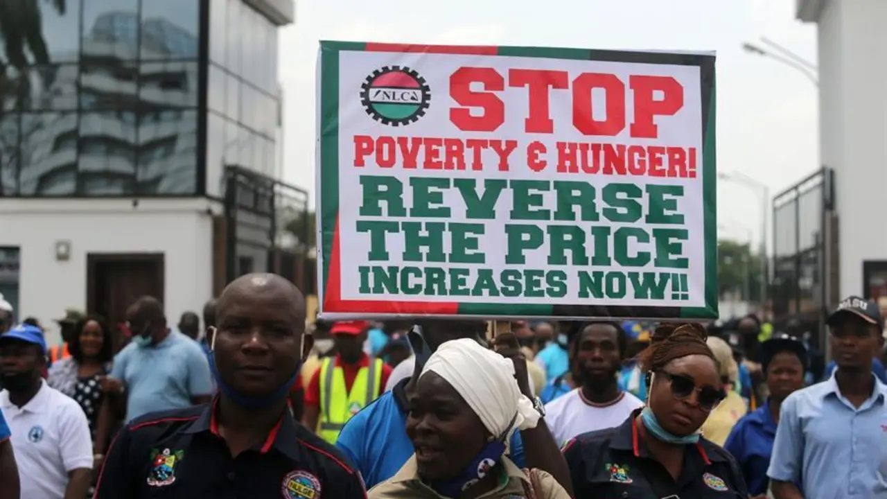 A worker holds a banner during a protest by the Nigeria Labour Congress (NLC) members, ahead of a planned nation-wide strike by the NLC, in Ikeja district in Lagos, Nigeria, 10 March 2021. The umbrella body of public workers in Nigeria, NLC protested on the streets of Lagos and other states in Nigeria on matters affecting their members, particularly on a planned removal of the minimum wage from the Federal government excLusive list by the Nigerian senate. (Protestas) EFE/EPA/AKINTUNDE AKINLEYE