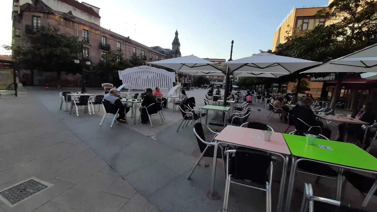 Vista de la terraza con varias personas en la plaza Baldomero Iglesias de Torrelavega. / S. D&iacute;az