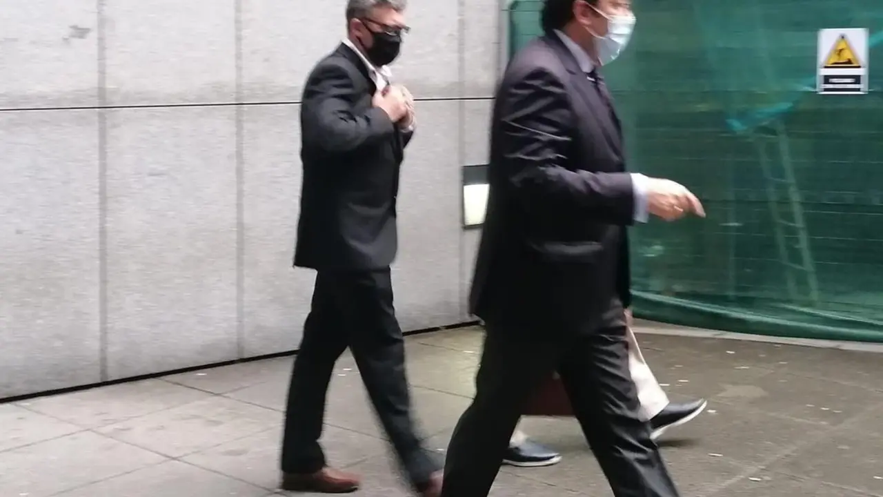 El condenado saliendo del juzgado detr&aacute;s de su abogado.
