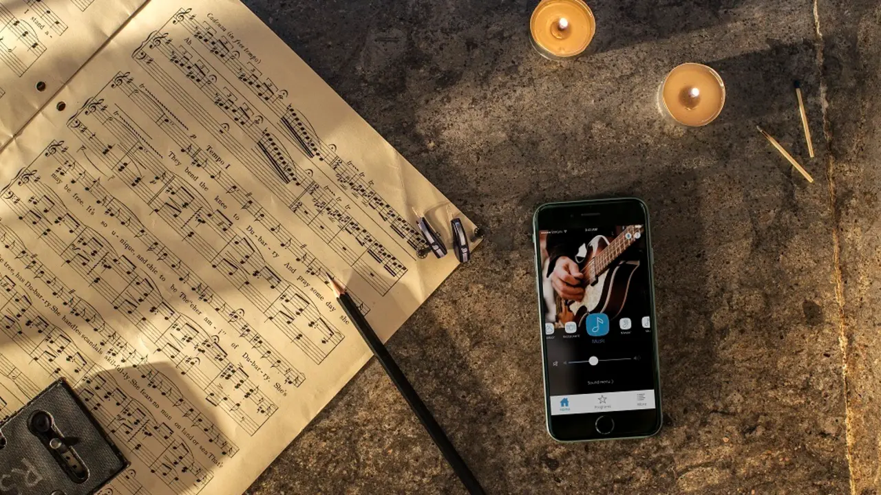 iPhone lying besides music program