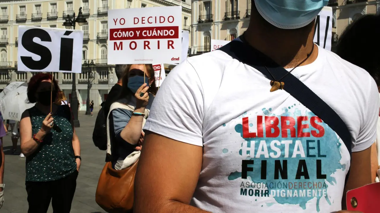 Un grupo de personas se re&uacute;ne sosteniendo pancartas y carteles durante la concentraci&oacute;n de la asociaci&oacute;n Derecho a Morir Dignamente (DMD). 