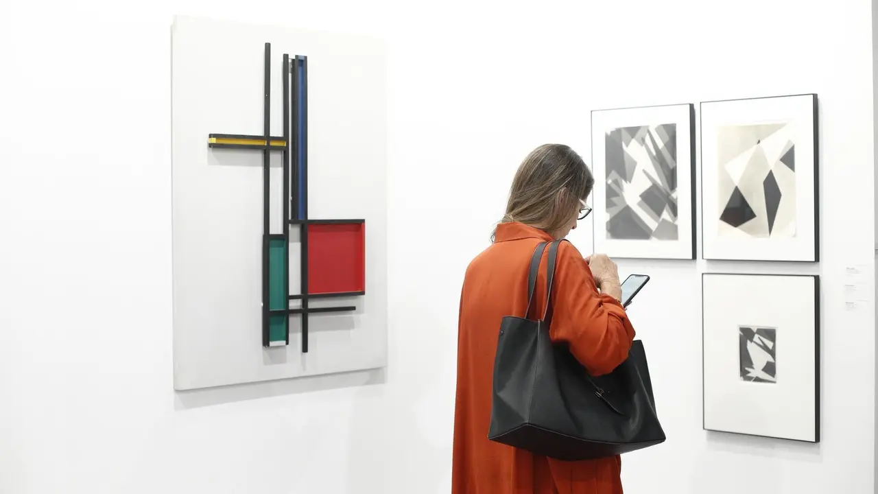 Archivo - Una mujer mira su m&oacute;vil durante la 38&ordf; edici&oacute;n de la Feria Internacional de Arte Contempor&aacute;neo ARCOmadrid.     