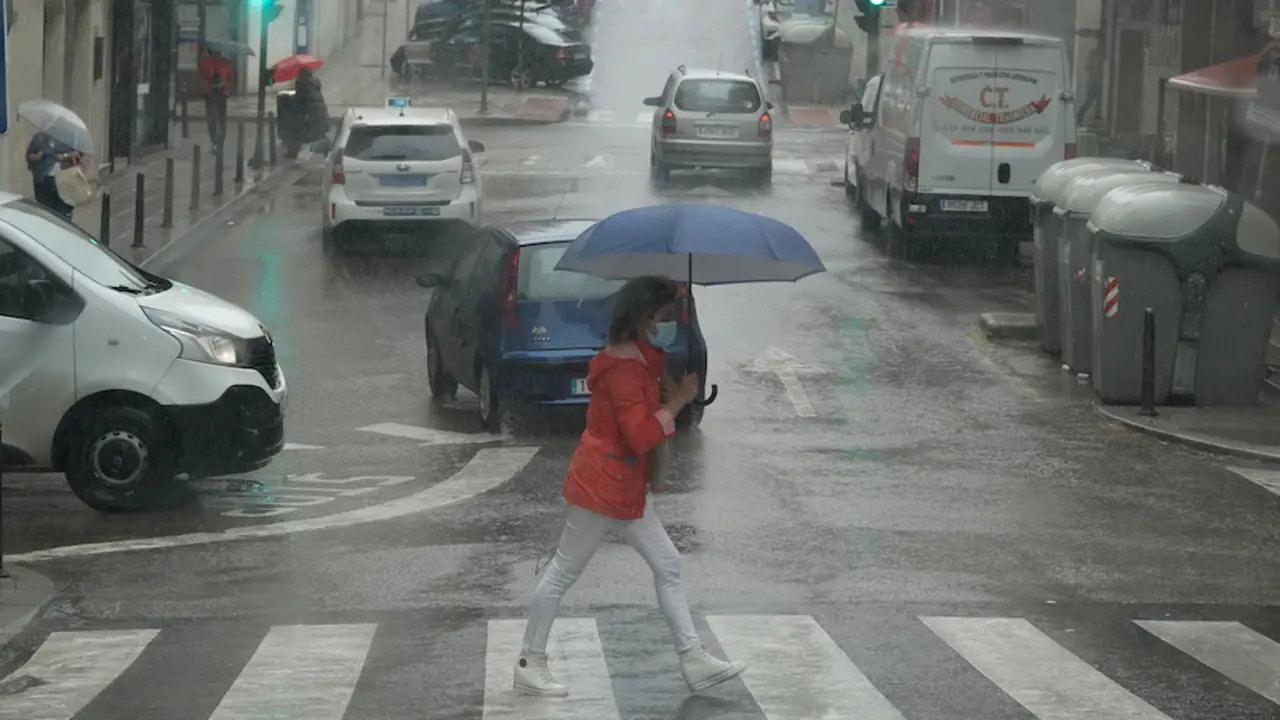 Varias personas transitan bajo la lluvia por las calles de Santander. / Hardy