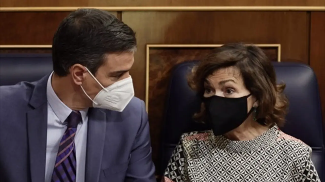 La vicepresidenta primera y ministra de la Presidencia, Relaciones con las Cortes y Memoria Democr&aacute;tica, Carmen Calvo, conversa con el presidente del Gobierno, Pedro S&aacute;nchez, en una sesi&oacute;n de control, a 16 de junio de 2021, - /E. Parra.