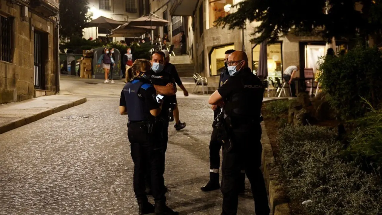 Varios agentes de la Polic&iacute;a Local y del Cuerpo Nacional de Polic&iacute;a, en la Praza dos Suaves, en un control policial para evitar botellones y aglomeraciones, a 4 de julio de 2021, en Ourense, Galicia (Espa&ntilde;a). Durante el fin de semana, las fuerzas y cuerpo