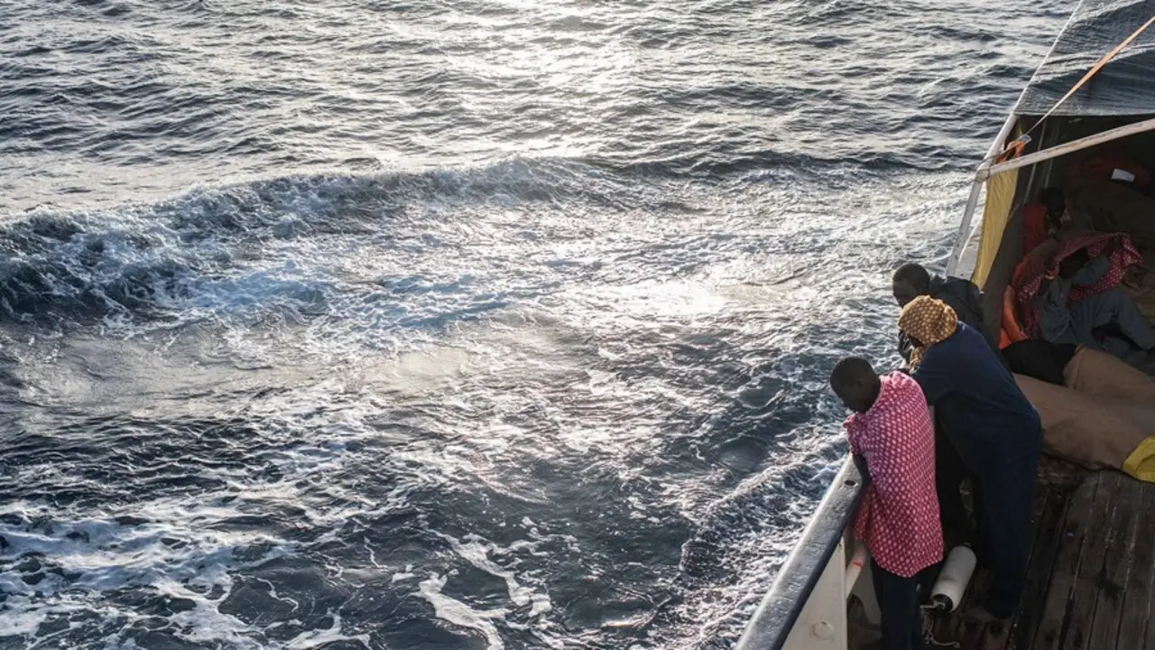 Archivo - Refugiados y migrantes miran por la borda en el Mediterr&aacute;neo desde la borda del Open Arms tras un rescate.