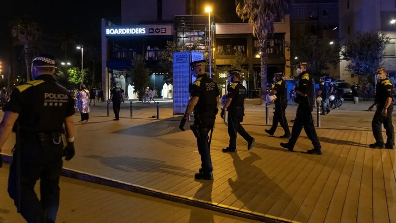 Agentes de la Guardia Urbana forman una l&iacute;nea tras desalojar la playa de la Barceloneta la noche en la que entra en vigor el toque de queda en Catalu&ntilde;a, a 16 de julio de 2021, en Barcelona, Catalunya (Espa&ntilde;a). El Tribunal Superior de Justicia de Catalu&ntilde;a 