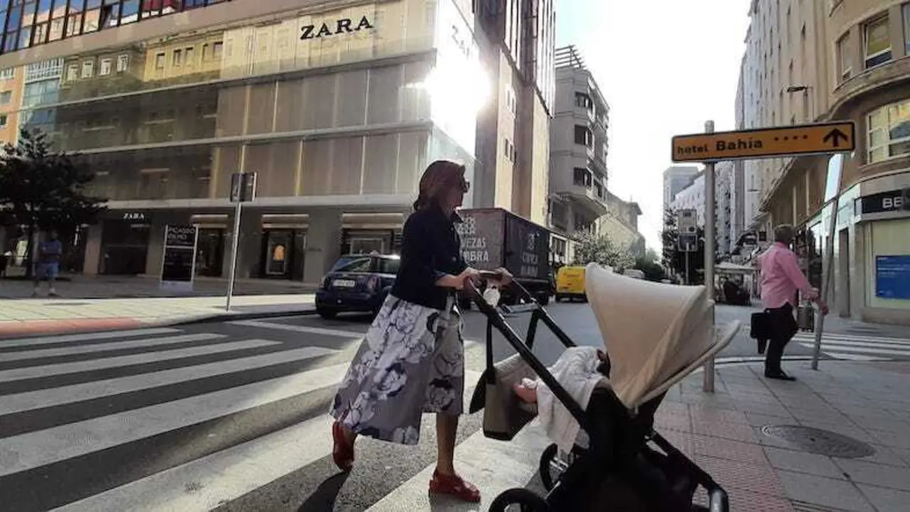 Una persona con mascarilla cruza una calle en el centro de Santander en el d&iacute;a de hoy. / S. D&iacute;az