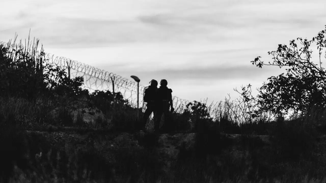 Archivo - Imagen de archivo de dos agentes de polic&iacute;a, frente a la frontera que separa Melilla y Marruecos, a 21 de mayo de 2021, en Marruecos
